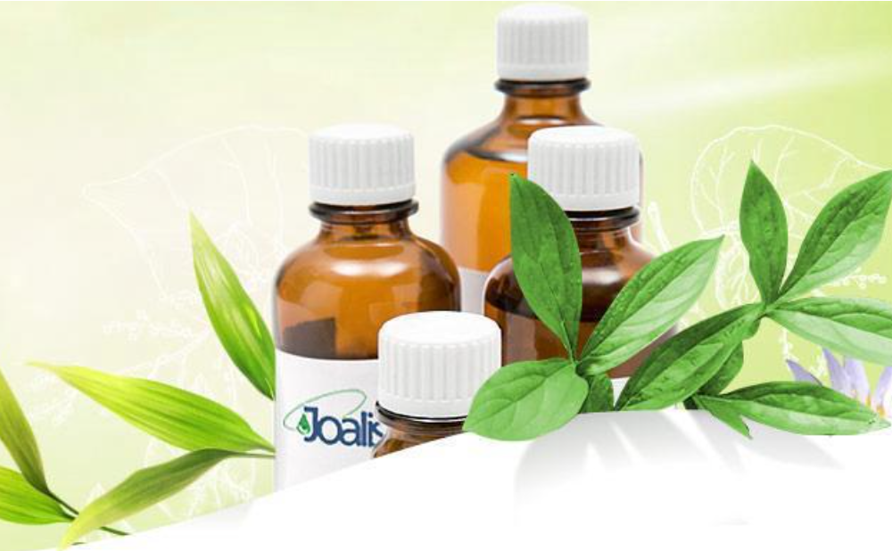 Braune Arzneifläschchen der Marke Joalis mit grünen Zweigen geschmückt